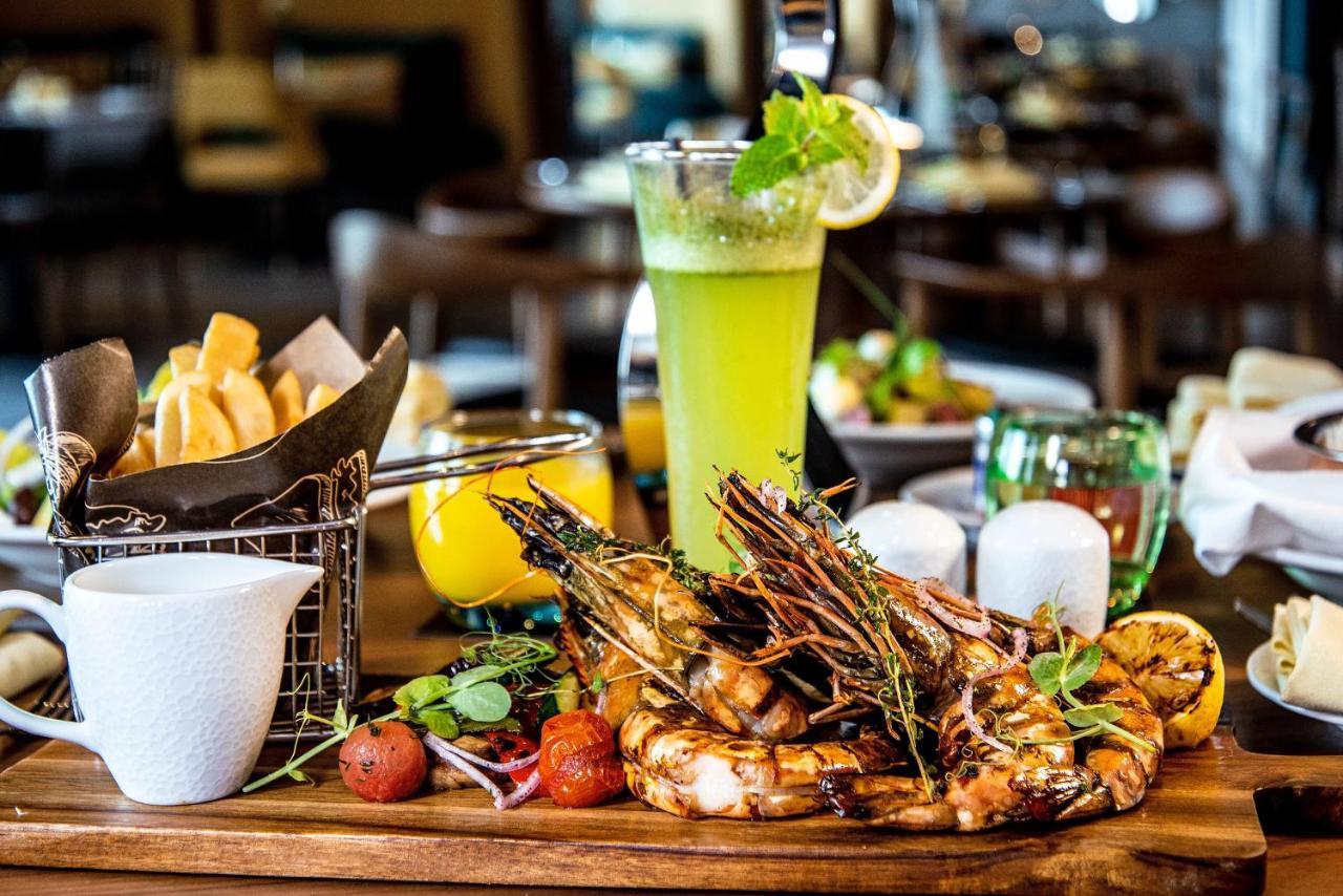 Pullman Sharjah Hotel Exterior photo A meal at the restaurant