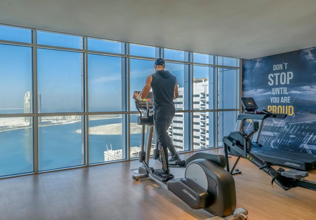 Pullman Sharjah Hotel Exterior photo A man using a cross trainer
