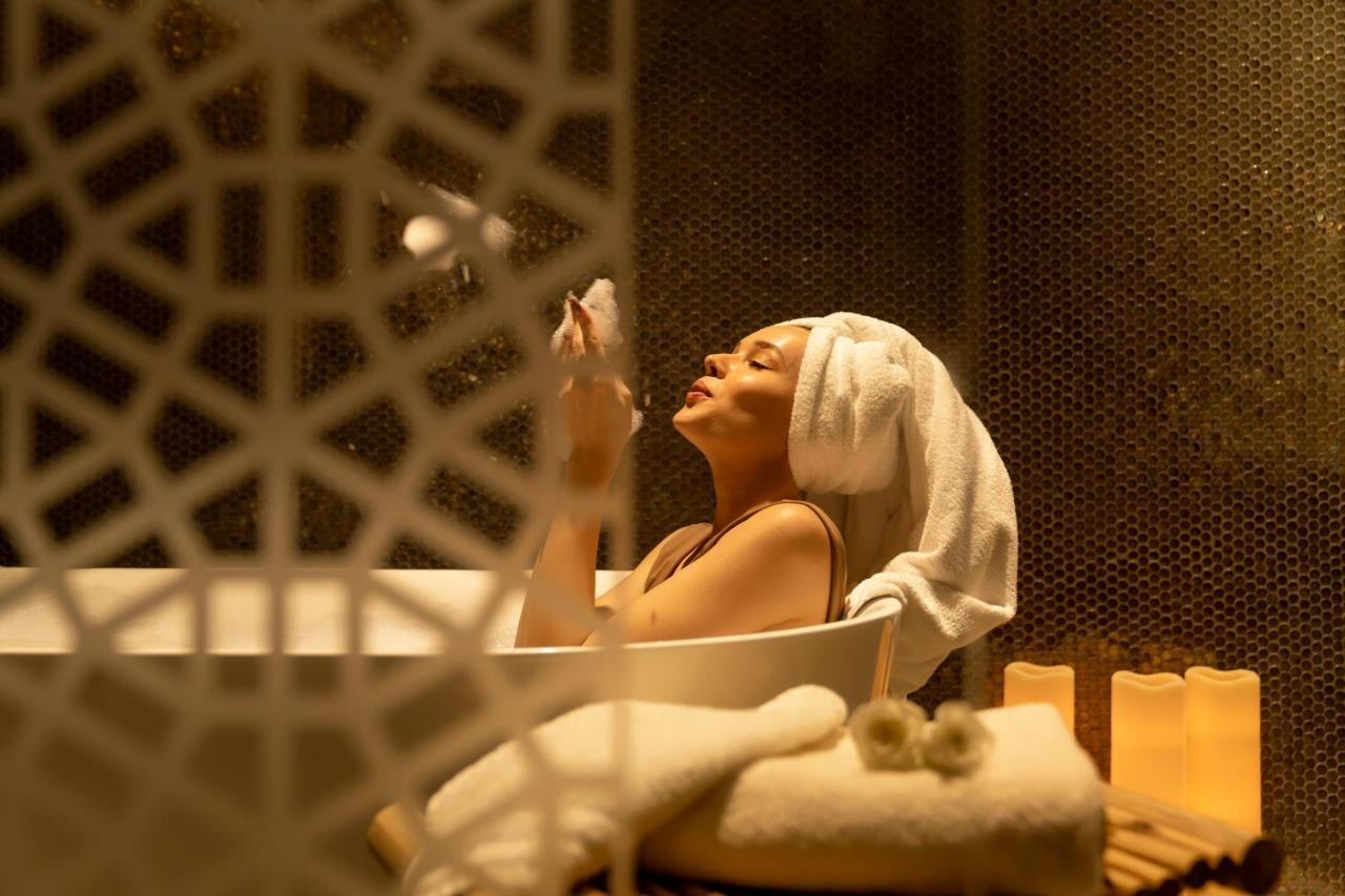 Pullman Sharjah Hotel Exterior photo A woman in a spa