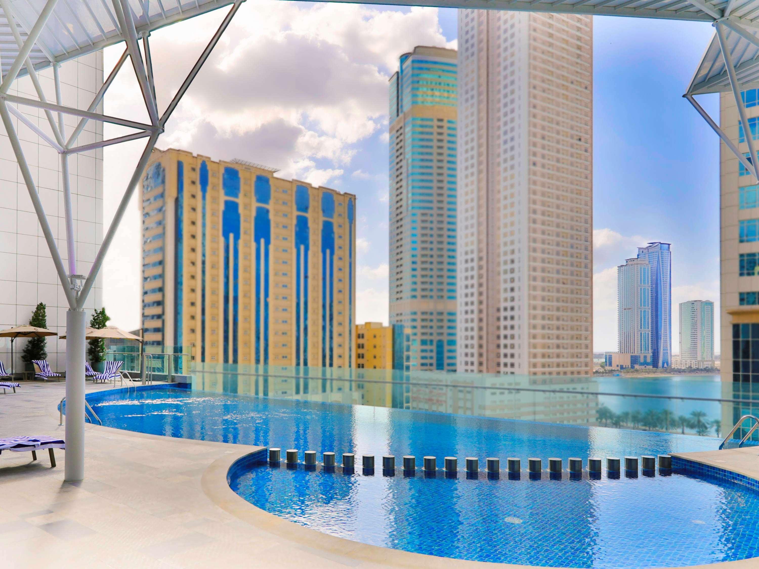 Pullman Sharjah Hotel Exterior photo The swimming pool at the complex