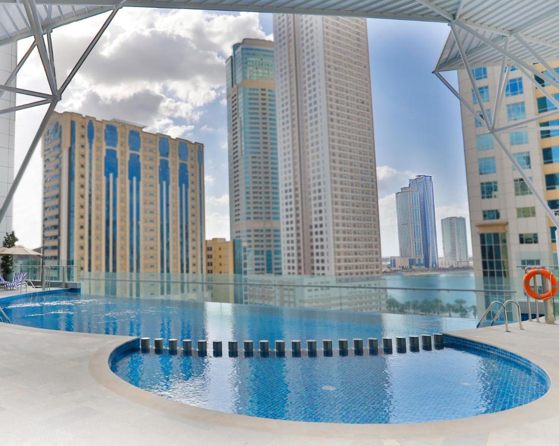 Pullman Sharjah Hotel Exterior photo The swimming pool at the complex